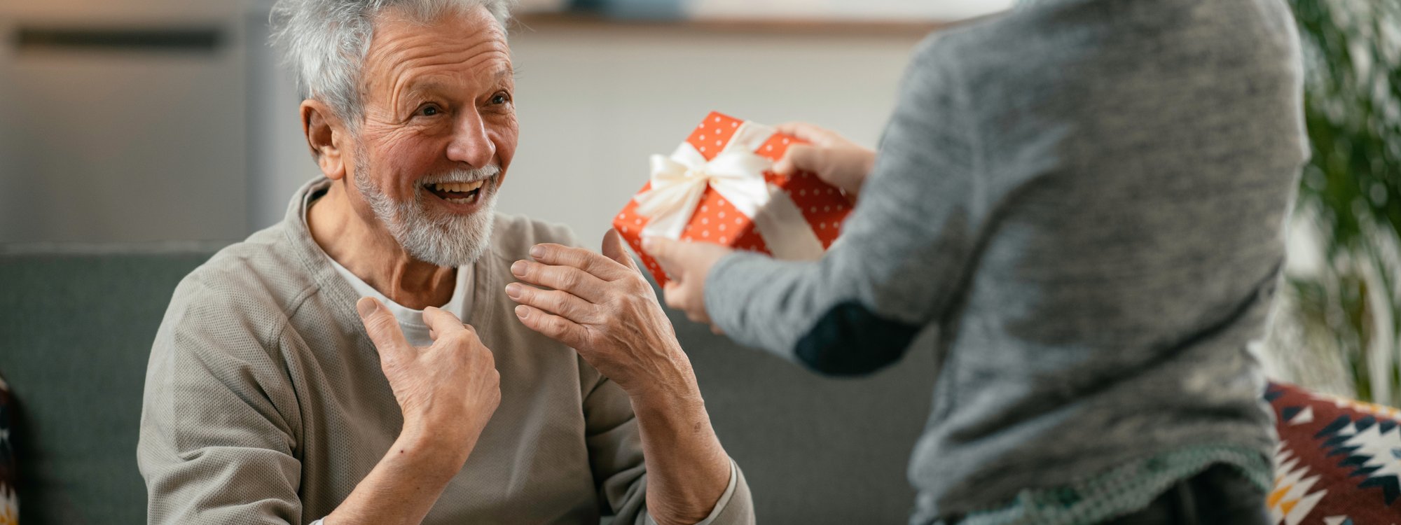 Child Giving Gift to Elder Family Member Child Giving Gift to Elder Family Member